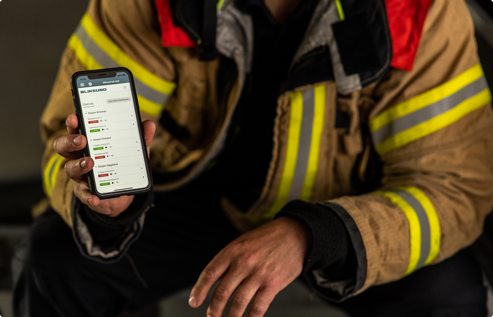 Brandmand viser det operationelle fagsystem GRID frem på en smartphone